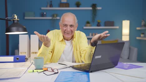 Home-office-worker-old-man-making-cute-gesture-at-camera.